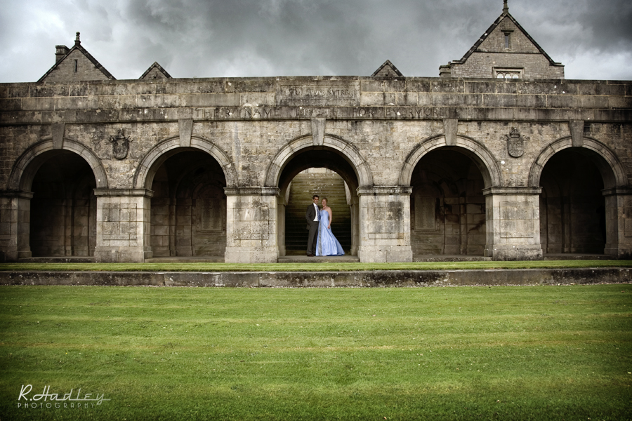 Wedding couple under the Sedbergh School arches, Cumbria.